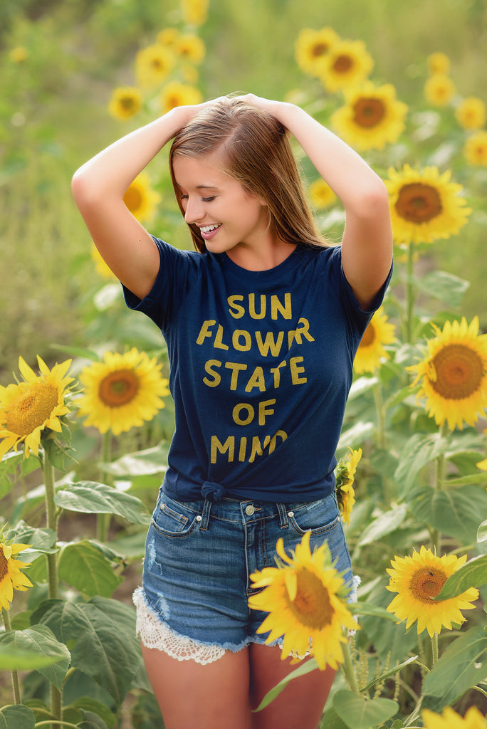 Person in a field of sunflowers. Photo by Studio Bloom by Shelley.